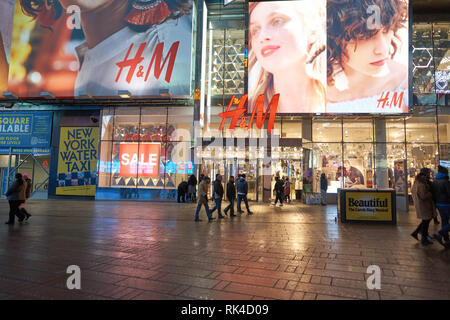 NEW YORK - CIRCA MARCH 2016: Times Square H&M store at night. H & M Hennes & Mauritz AB is a Swedish multinational retail-clothing company, known for  Stock Photo