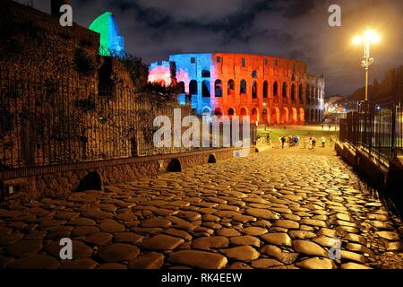 Colorful Colosseum at night with stone pattern street, the world known ...
