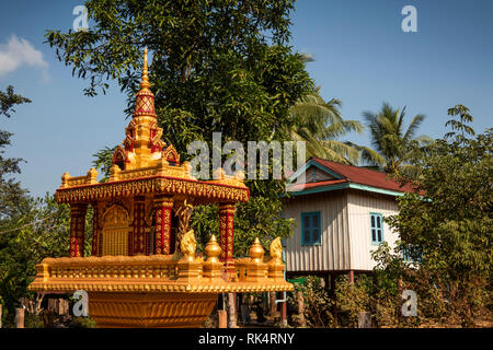 Cambodia, Koh Kong Province, Chi Phat, ornate gold painted Buddhist spirit house outside village house Stock Photo
