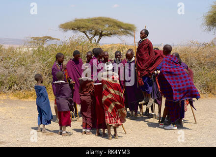 Serengeti, Tanzania - July 31 2008: Masai jumping high while performing a ritual dance in the Serengeti, Tanzania. Stock Photo