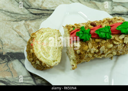 Close view of two pieces of honey cake on a plate nine layers covered with delicious sour cream and walnuts . Stock Photo