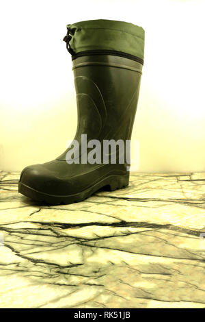Pair of green rubber boots isolated on white . Stock Photo