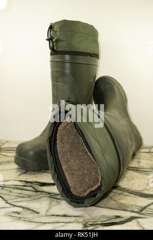 old rubber men's boots, inside insulated with fur. isolated on white background. Stock Photo