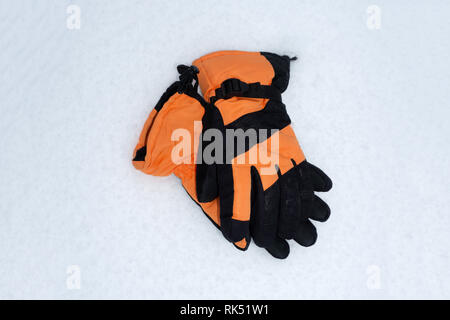 Caps mittens, gloves and socks are stacked in a circle View from above Warm clothes in the form of hats mittens gloves and socks for autumn and winter Stock Photo