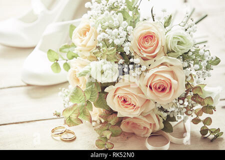 Marriage day setting with bridal bouquet of pink roses, white