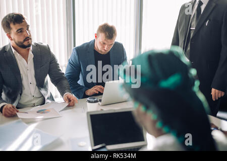 Collaborative process of multicultural professional financial or marketing managers during brainstorming meeting in office, headed by mature Senior He Stock Photo