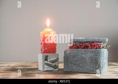 Jewelry box and candle holder with candle decorations on a wooden base Stock Photo