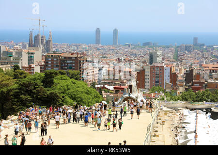 BARCELONA, SPAIN - JULY 12, 2018: cityscape of Barcelona from Park Guell with tourists, Barcelona, Spain Stock Photo