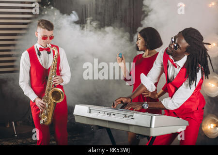 rock and roll band performing music on the smoky stage. close up photo Stock Photo