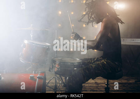 awesome stylish man performing on the stage woth smoke. close up side view photo. event Stock Photo