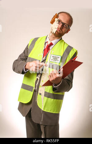 Health and Safety office getting hit in the face with a cream pie Stock Photo