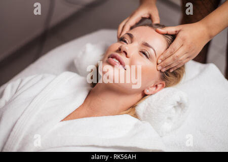 cheerful awesome attractive girl rejuvenates her skin in the spa salon. close up photo Stock Photo