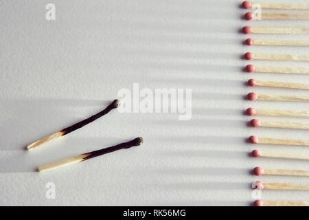 burned matches on a white background, a bunch of matches. and long shadows Stock Photo