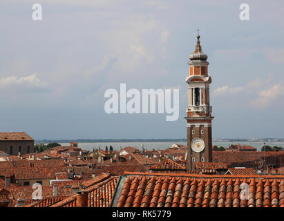 ancient bell tower of the church called Santi Apostoli and the roofs of the island of Venice in Italy Stock Photo