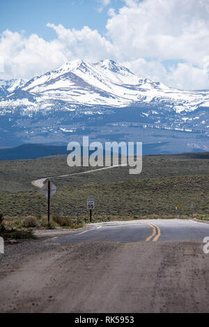 The pavement ends and the dirt road begins on California State Highway 270 near Bodie Ghost Town in the Eastern Sierra Nevada Mountains. Stock Photo