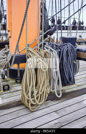 Rigging rope detail on HMS Warrior being held in place by belaying pins Stock Photo