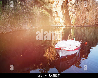 small authentic boat in the Bay with blue water Stock Photo
