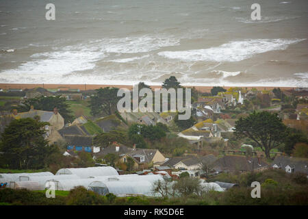 The village of West Bexington overlooking Chesil beach with Storm Erik creating some large waves. Dorset England UK GB. 8.2.2019 Stock Photo