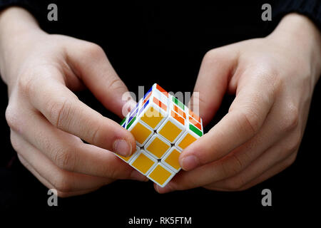 a person trying to equalize the colors of the intelligence cube, Stock Photo