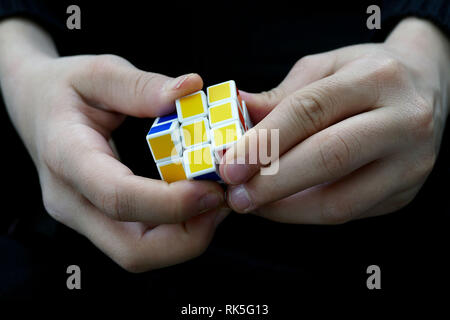 a person trying to equalize the colors of the intelligence cube, Stock Photo