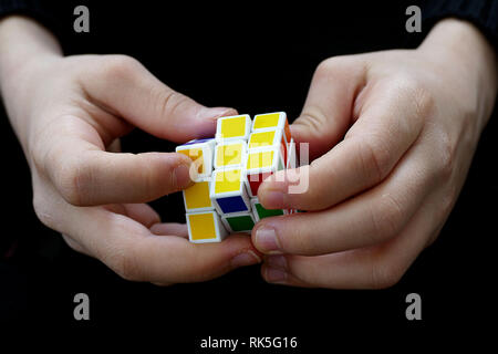 a person trying to equalize the colors of the intelligence cube, Stock Photo