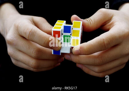 a person trying to equalize the colors of the intelligence cube, Stock Photo