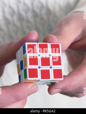 a person trying to equalize the colors of the intelligence cube, Stock Photo