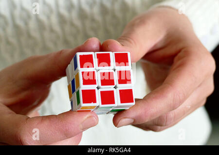 a person trying to equalize the colors of the intelligence cube, Stock Photo