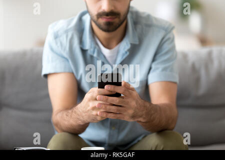 Man holding phone in hands texting message using mobile apps Stock Photo