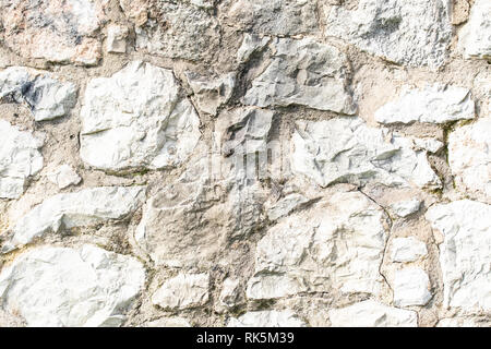 Gray wall background of uneven, different stones. Stock Photo