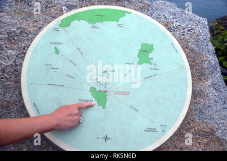 Woman's Finger Pointing to Guernsey on a Map on the Headland of Jerbourg Point on the Coastal Path on Guernsey, Channel Islands.UK. Stock Photo