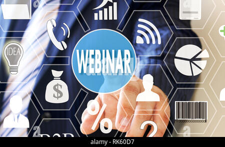 The businessman clicks WEBINAR button on the touch screen Stock Photo