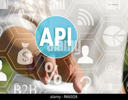 Businesswoman pushes a button API, Application Programming Interface on the touch screen Stock Photo