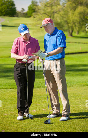 Mature Golfers Checking Distance at Tee Box Before Teeing Off, USA Stock Photo