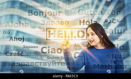 Young woman touching digital screen interface choosing word hello translated in different languages. Multilingual teacher learning and speaking many l Stock Photo