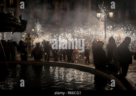 Barcelona, Spain. 9th Feb 2019. In Barcelona Catalan devils burn gunpowder close to a fountain    during the correfoc for Santa Eulalia Festival. Correfocs, an old Catalan tradition where people dressed as devils blow up firecrackers and flares, take part in many local  celebrations and festivals. Credit:  Jordi Boixareu/Alamy Live News Stock Photo