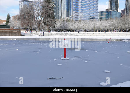 Bellevue, WA, USA. 9th Feb, 2019. The Downtown Park lake is frozen and emergency Keep Out signs are posted Stock Photo