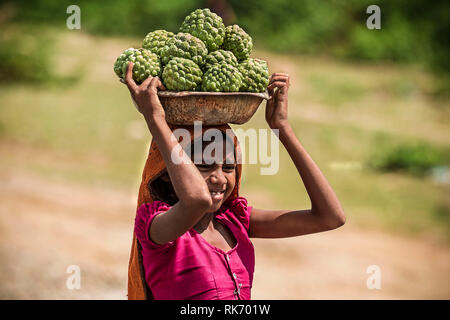 Girl selling vegetables on roadside Stock Photo