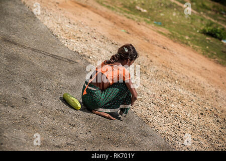 Girl selling vegetables on roadside Stock Photo