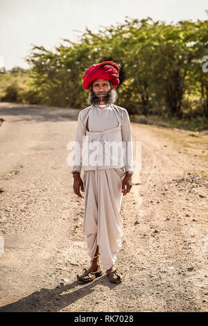 Rajasthani man wearing white traditional dress and red turban Stock Photo