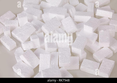 Filler packing background. Packaging foam pellets texture, top view, close-up. Polystyrene, white styrofoam packing peanuts used to prevent damage to Stock Photo