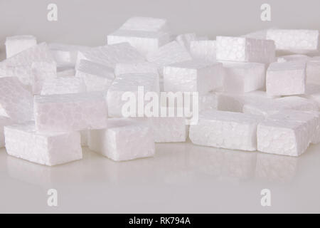 Filler packing background. Packaging foam pellets texture, top view, close-up. Polystyrene, white styrofoam packing peanuts used to prevent damage to Stock Photo