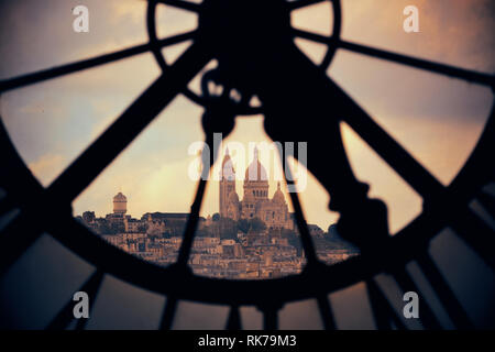 Sacre-Coeur viewed through Giant clock tower in Paris, France. Stock Photo