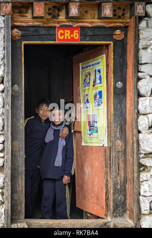 Two happy boys at the door of a class at Laya school, Gasa District, Snowman Trek, Bhutan Stock Photo