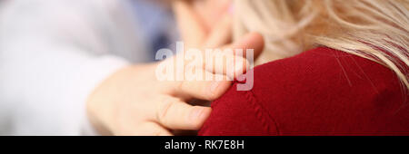 Young male doctor holds sick patient by hand Stock Photo