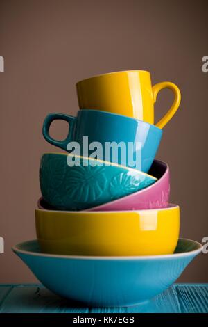 https://l450v.alamy.com/450v/rk7egb/bright-ceramics-cups-and-bowls-in-blue-yellow-and-pink-colors-rk7egb.jpg