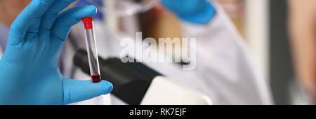 Male hand in blue protective gloves holding Stock Photo