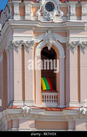 The flag of Lithuania flies in the arch of Church of St. Casimir in Vilnius - festive decoration for February 16, Lithuania's Independence Day Stock Photo