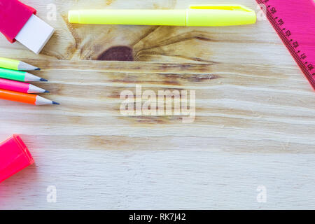 School and drawing supplies, on wooden table. Pencils, eraser, sharpener, highlighter and ruler. With copy space. Stock Photo