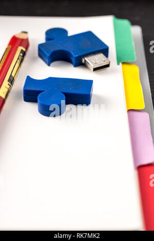 still life with blocknote, labtop, pen and a white mug of coffee over a black office desk. symbol of job Stock Photo